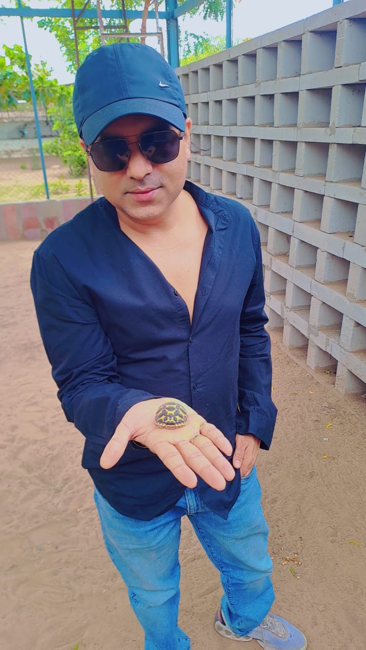 Nizi Bhandari holding a rescued baby turtle
