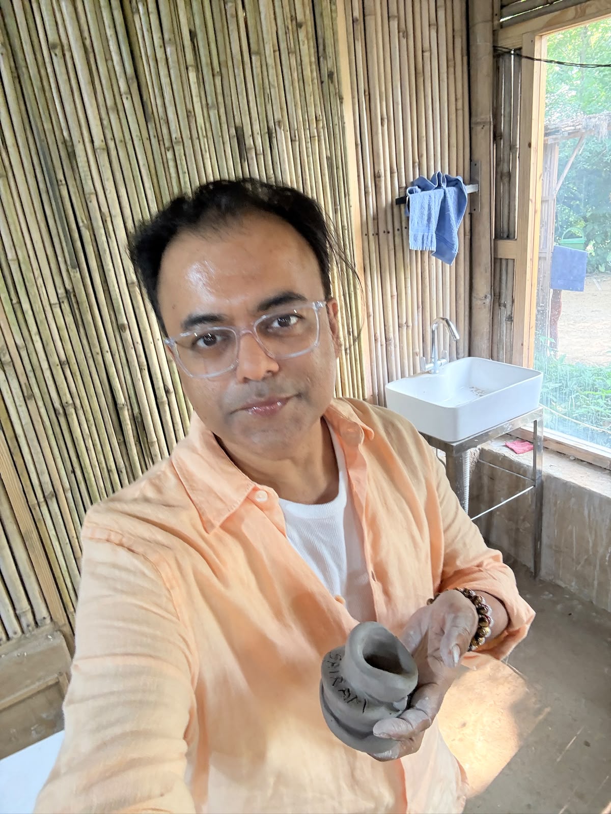 Nizi Bhandari shaping clay in a bamboo pottery studio