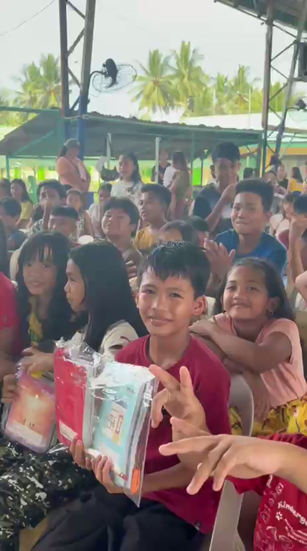 Nizi Bhandari handing out school supplies in the Philippines